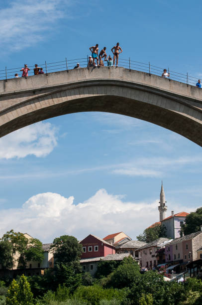 Bosnia: divers before jumping from the Stari Most (Old Bridge), the Ottoman bridge from which the traditional race of dips in the Neretva River has been held for more than 450 years Mostar, Bosnia Herzegovina, Europe - July 7, 2018: divers before jumping from the Stari Most (Old Bridge), the Ottoman bridge from which the traditional race of dips in the Neretva River has been held for more than 450 years stari most mostar stock pictures, royalty-free photos & images