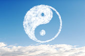 white cloud on a background of blue sky in the shape of yin yang