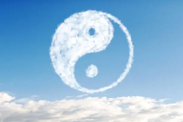 cloud on a background of blue sky in the shape of yin yang