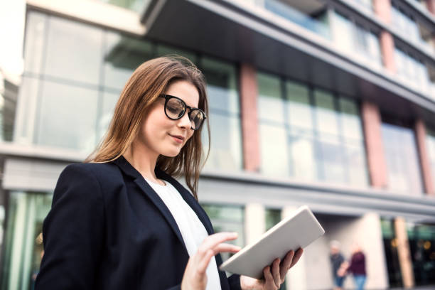 istock A young businesswoman using tablet outdoors in front of a building. 1028723186