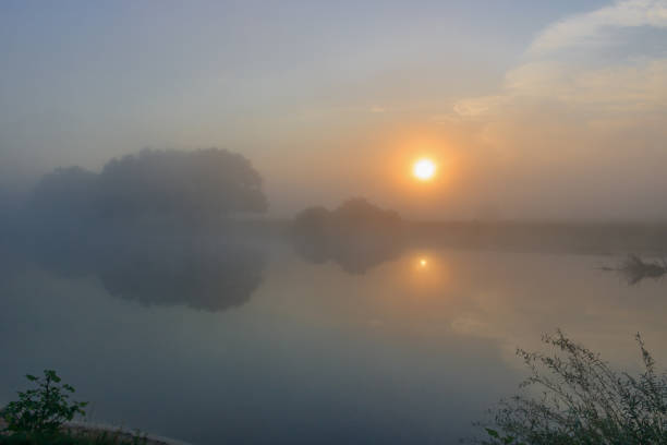 istock Fog above the river surface. River landscape at sunrise in summer morning 1028724128