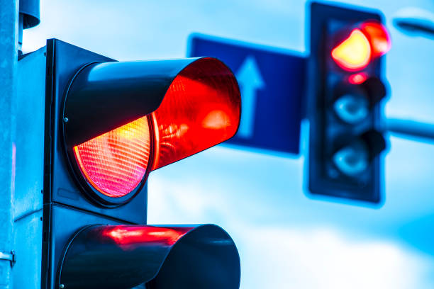 Traffic lights over urban intersection Traffic lights over urban intersection. red light stock pictures, royalty-free photos & images