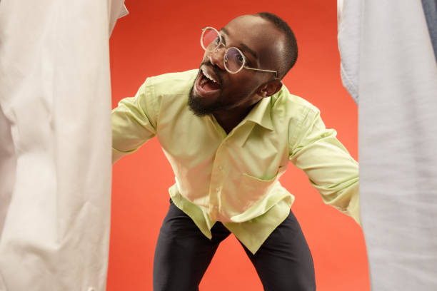 istock Handsome man with beard choosing shirt in a shop 1028735712