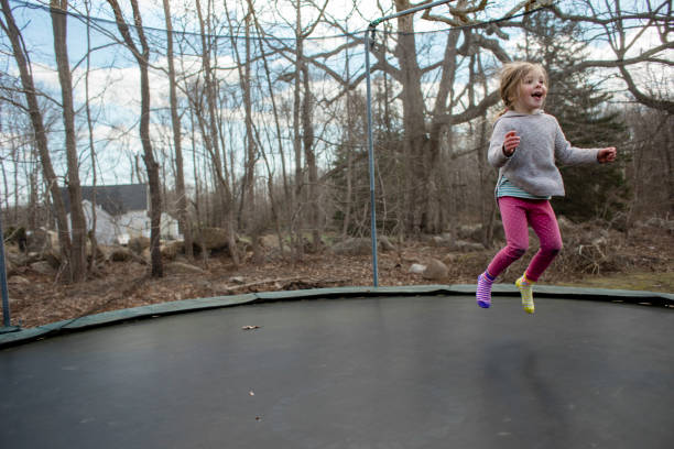 istock Little girl jumping on a trampoline 1028739678