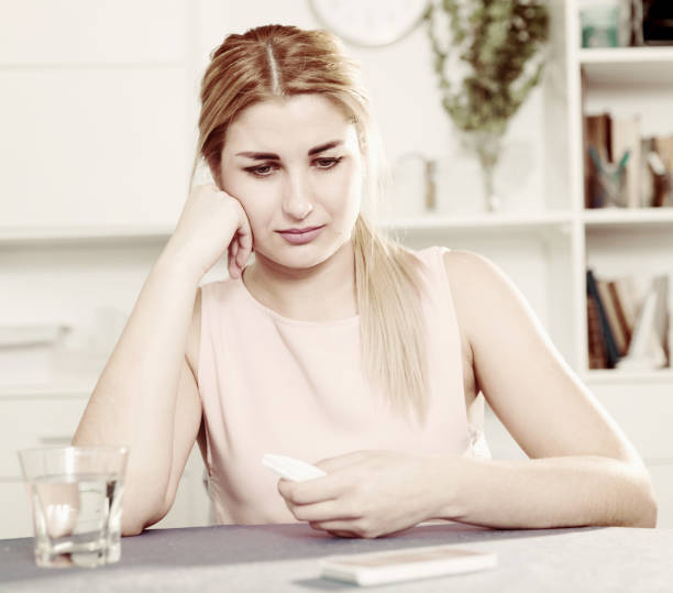 istock Young female is thoughtful and bored sitting alone 1028740912