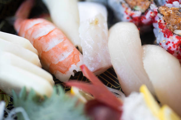 Sushi Set sashimi and sushi rolls served on stone slate. High quality photo