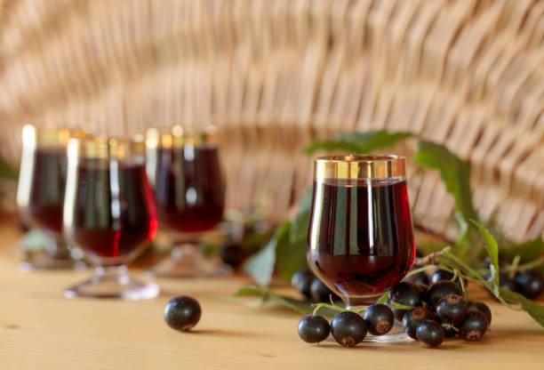 istock Homemade black currant liqueur and fresh berries. 1028757242