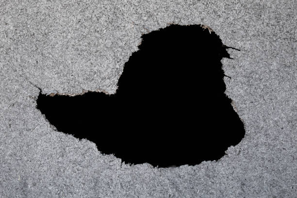 istock Hole in the destruction concrete wall bullet hole abstract background free space for design 1028757346