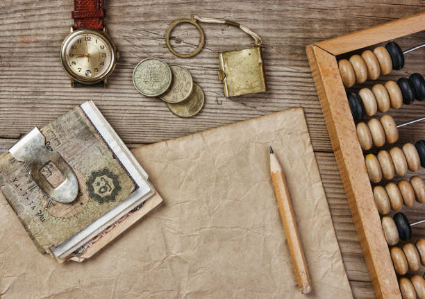 istock Old notes and coins and abacus on a wooden table 1028765908