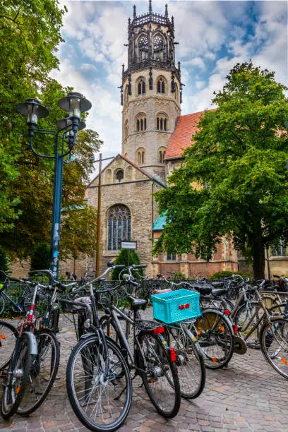 Built in 1173 St. Ludgeri is the oldest Catholic church in Münster. Bicycles in the foreground. Münster - Germany.