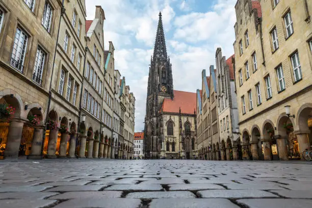 Gallery with arcades on the Prinzipalmarkt in Münster
,shaped by historic buildings  The Prinzipalmarkt is the historic principal marketplace of Münster, Germany. Low angle view with cobblestones in the foreground.