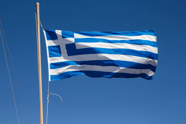 istock Greek flag isolated on a blue sky 1028767450