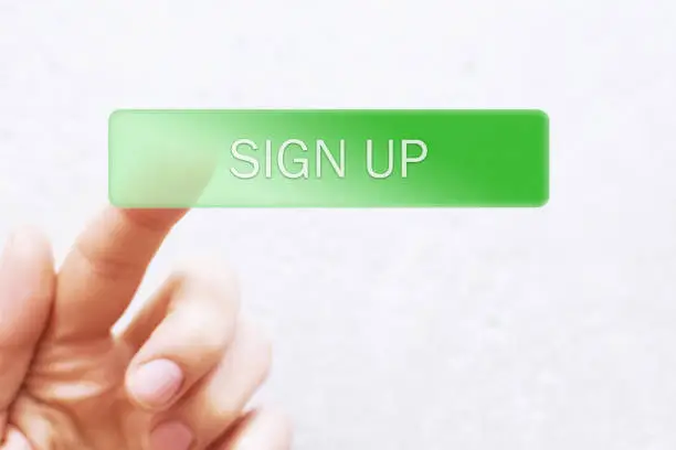 Photo of Finger pressing green transparent sign up button