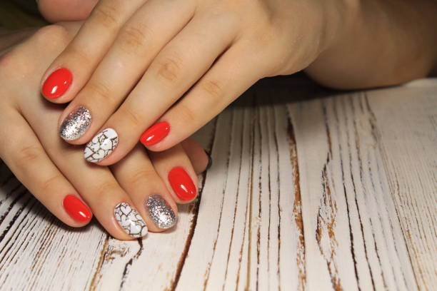 istock Manicured nails colored with red nail polish 1028772510