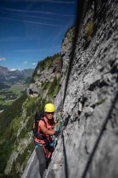 istock Pretty, female climber on a via ferrata 1028773052