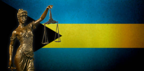 istock Lady Justice before a Bahamian flag 1028779544