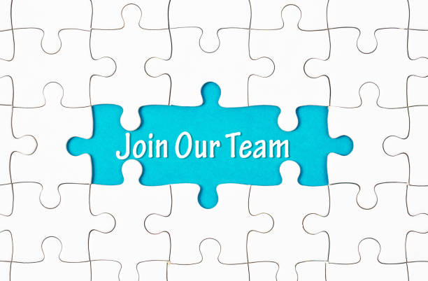 istock Join Our Team texts with white jigsaw puzzle board 1028782752