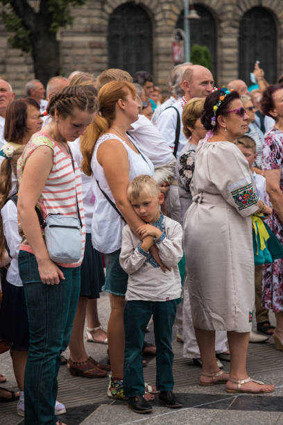 Lviv, Ukraine - August 24, 2018: Ukraine’s Independence Day commemorates the anniversary of the country’s independence. Prior to 1991, Ukraine was a constituent republic of the Union of Soviet Socialist Republics (U.S.S.R.). On August 24, 1991, after a failed coup in Moscow, Ukraine declared its independence. There are a lot of activities in all around the country. Here, priests get together to sing divine. Women are listening to them as they get lost. The child is tired.