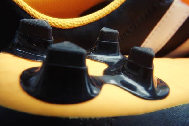 Football shoes on color background, top view
