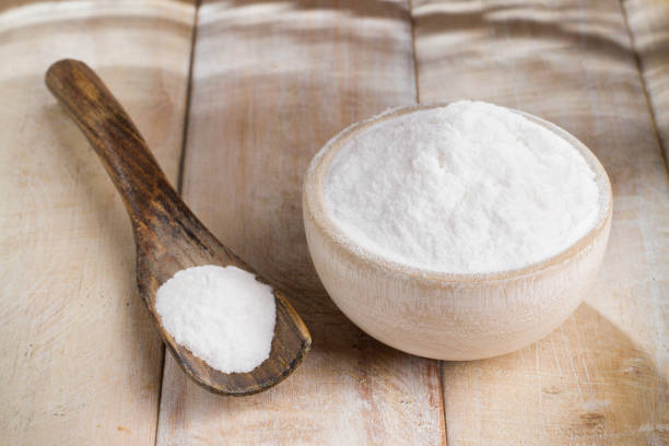 istock baking soda in bowl on wooden table, close up 1028806304