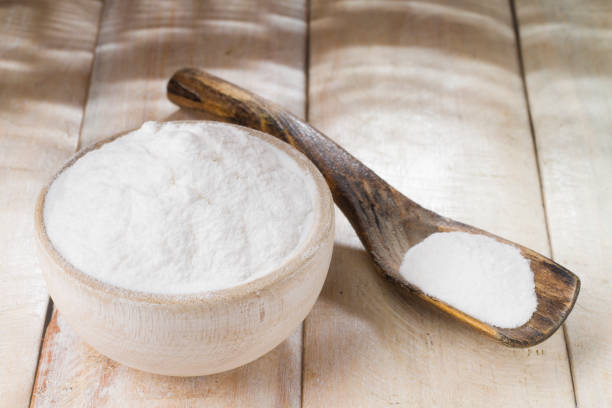 istock baking soda in bowl on wooden table, close up 1028806394
