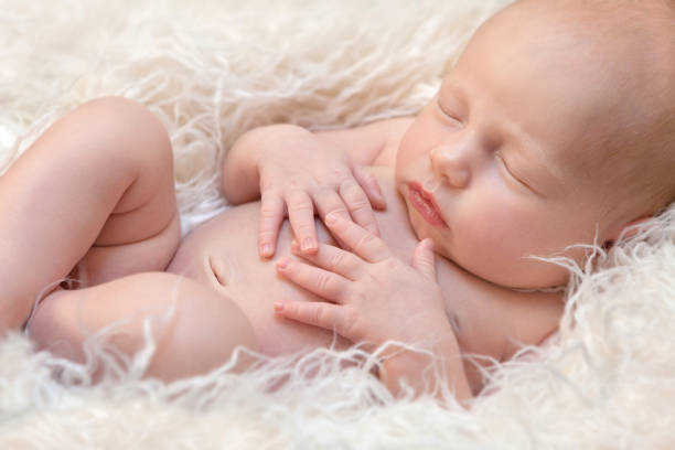 Newborn baby girl Newborn baby girl sleeping on a fluff navel stock pictures, royalty-free photos & images