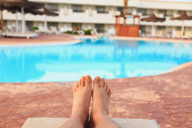 istock male feet on swimming pool background 1028810634