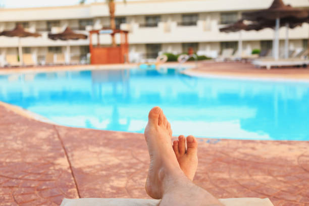 istock male feet on swimming pool background 1028814812