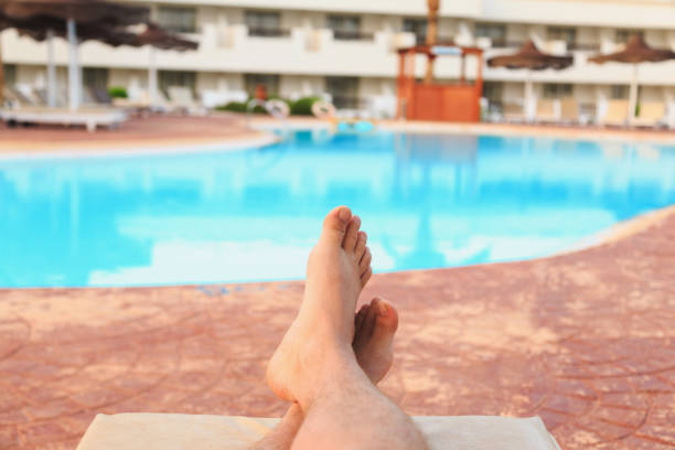 istock male feet on swimming pool background 1028814876