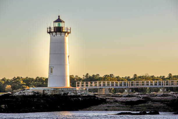 lighthouse by the sea at sunset a picture of a lighthouse by the sea at sunset portsmouth nh stock pictures, royalty-free photos & images
