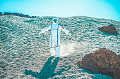 Astronaut discovering new blue planet - Spaceman traveling universe looking for a new world to colonizing - Spacewalking and future concept - Focus on him