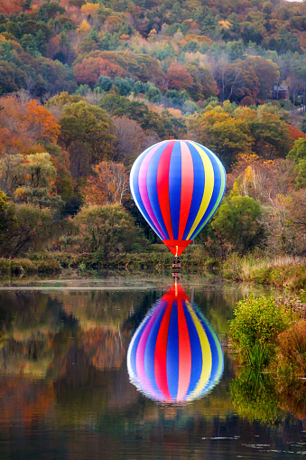 a picture of a hot air ballon over a pond