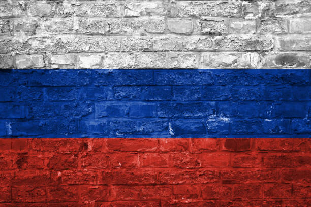 istock Flag of Russia over an old brick wall background, surface 1028826752