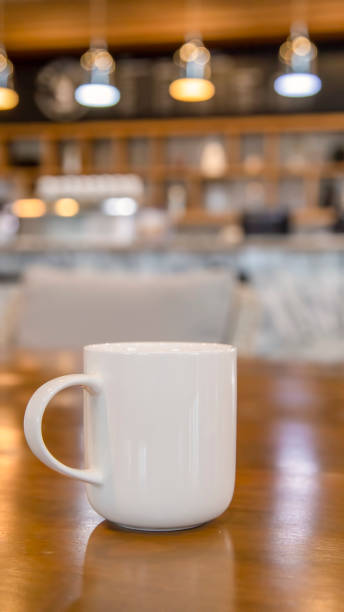 istock Cup of coffee on table with cafe background 1028827186
