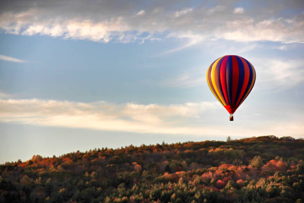 a picture of a hot air ballon over a mountain