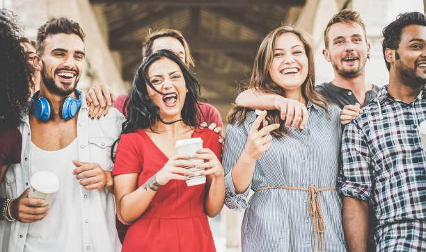 istock Happy students having fun in old city center drinking coffee - Young people at university break enjoying time together - Youth and positive mood with friends concept - Focus on right woman face 1028831132