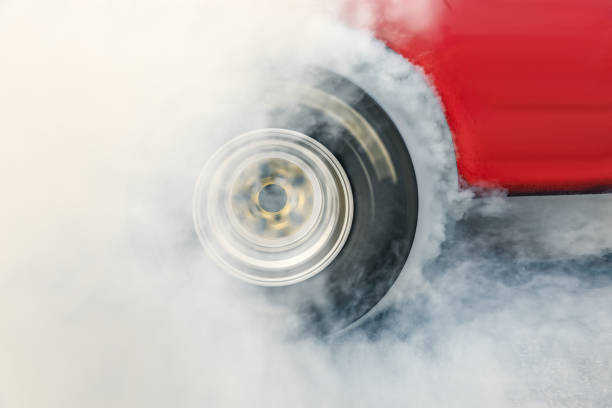 istock Drag racing car burn tire at start line 1028834424