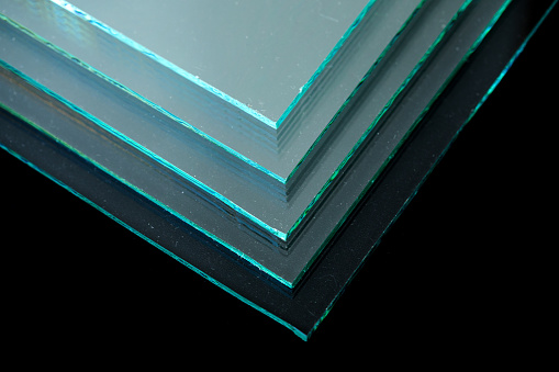 Sheets of Factory manufacturing tempered clear float glass panels cut to size.
