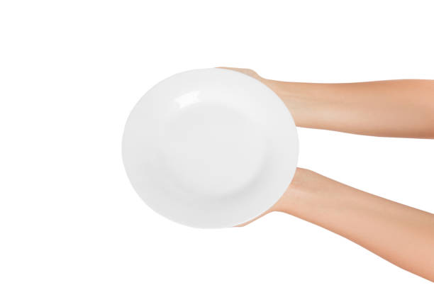 istock Blank empty round plate in female hand. perspective view, isolated on white background 1028842262