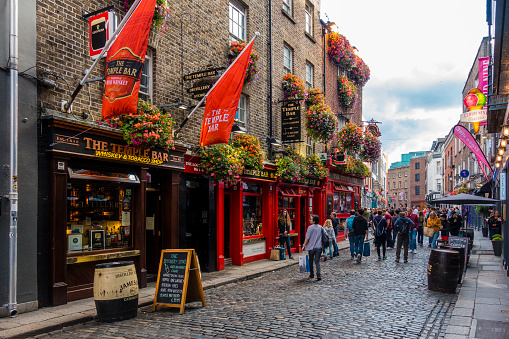 Dublin, Ireland - July 29, 2018: Tourists walking around in Temple Bar Area in Dublin. It is a famous quarter with many pubs and restaurants.