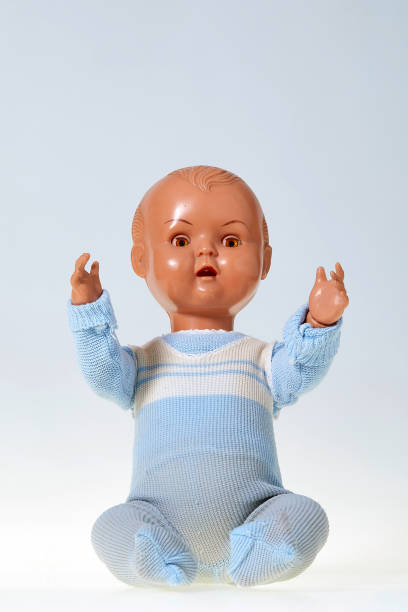 istock Vintage boy doll with raised arms on white blue background 1028853232