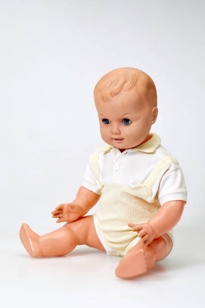 istock Vintage boy doll sitting on white background 1028853406