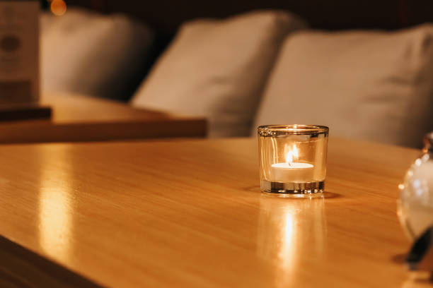 istock A small candle burns in a glass on a wooden table 1028854122