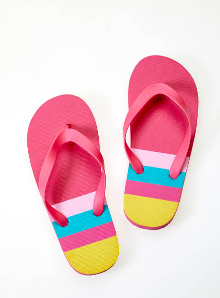 Colorful slippers on white background from above stock photo