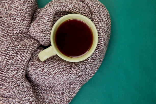 istock Knitted scarf with warm  cup of tea 1028858110