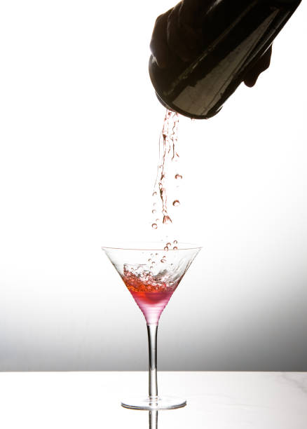 istock Cocktail being poured into martini glass 1028866176