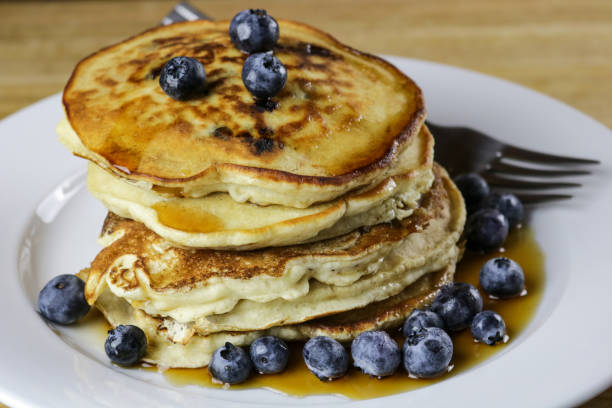 Stack of Blueberry Pancakes with Maple Syrup and Fresh Blueberries