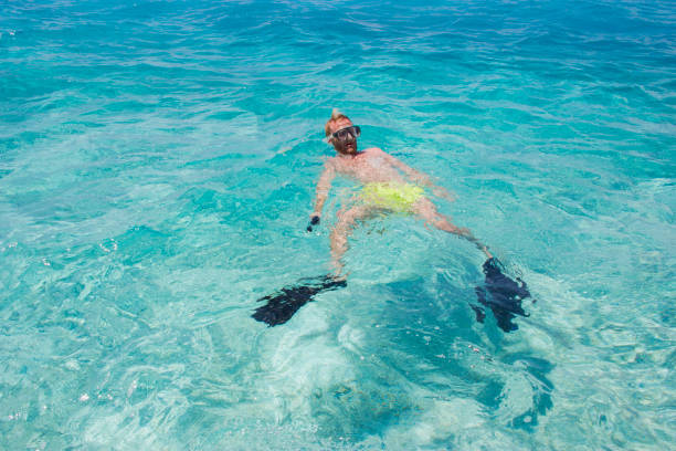 istock Caucasian man swimming  in a tropical beach 1028866310