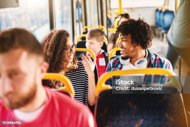 Cute Young Multicultural Couple Having Fun In A Public Transportation Stock Photo - Download Image Now