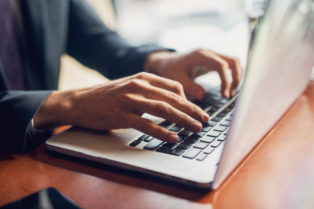 Close up of a hands of a businessman on a keyboard. Close up of a hands of a businessman on a keyboard. using computer stock pictures, royalty-free photos & images